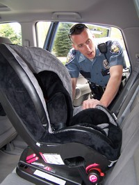 Police Officer performing a child safety seat check